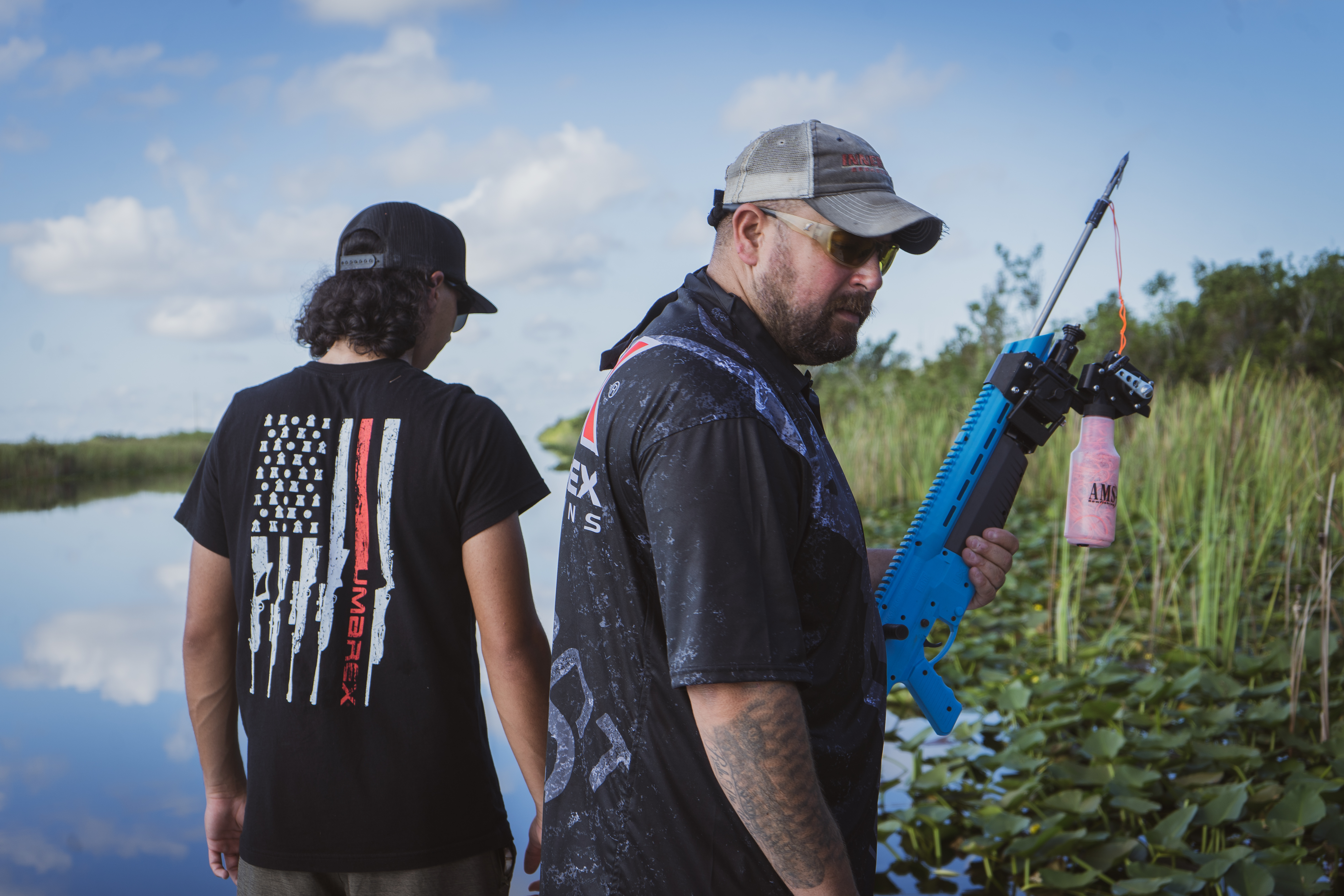 Corey Brossman aiming the Umarex FISHR from a boat